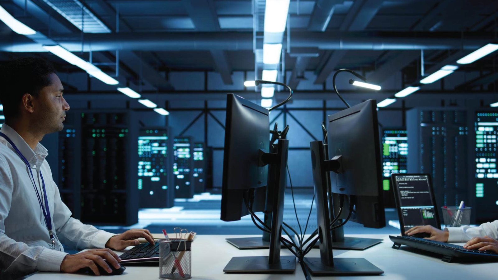 Airspan engineers monitoring 5G network performance in a high-tech data center environment.