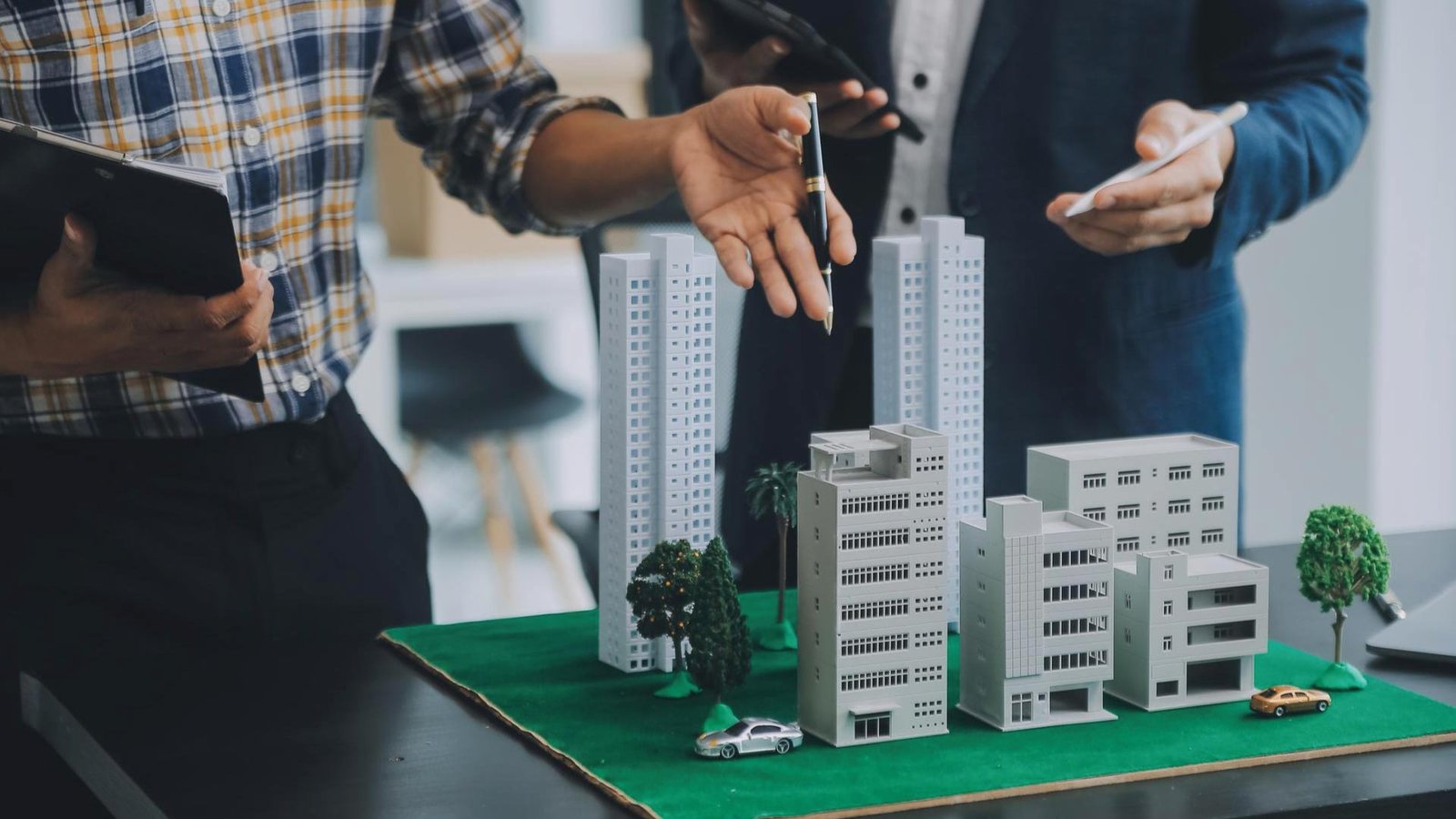 Brisa Development Partners team reviewing a scale model for a new affordable housing project in California.