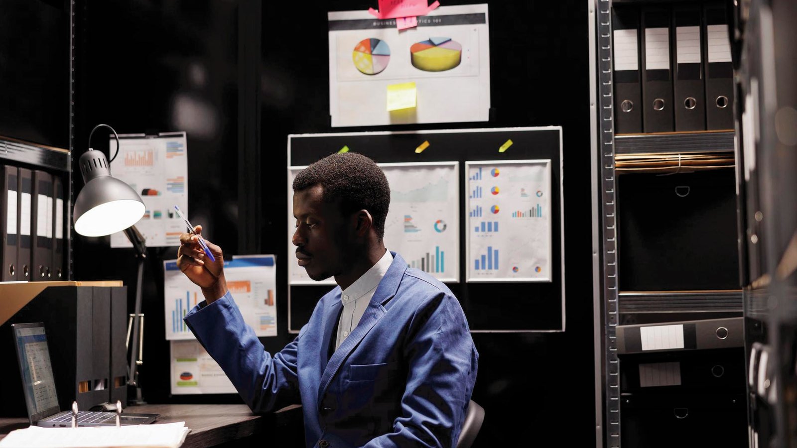 Africa business professional analyzing charts.