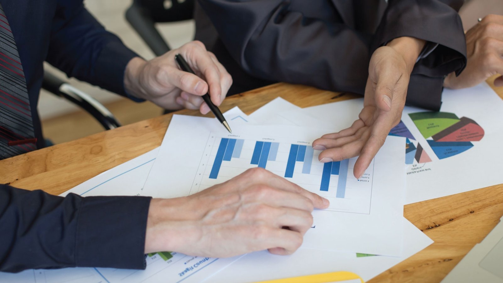 Brennan team reviewing real estate performance charts.