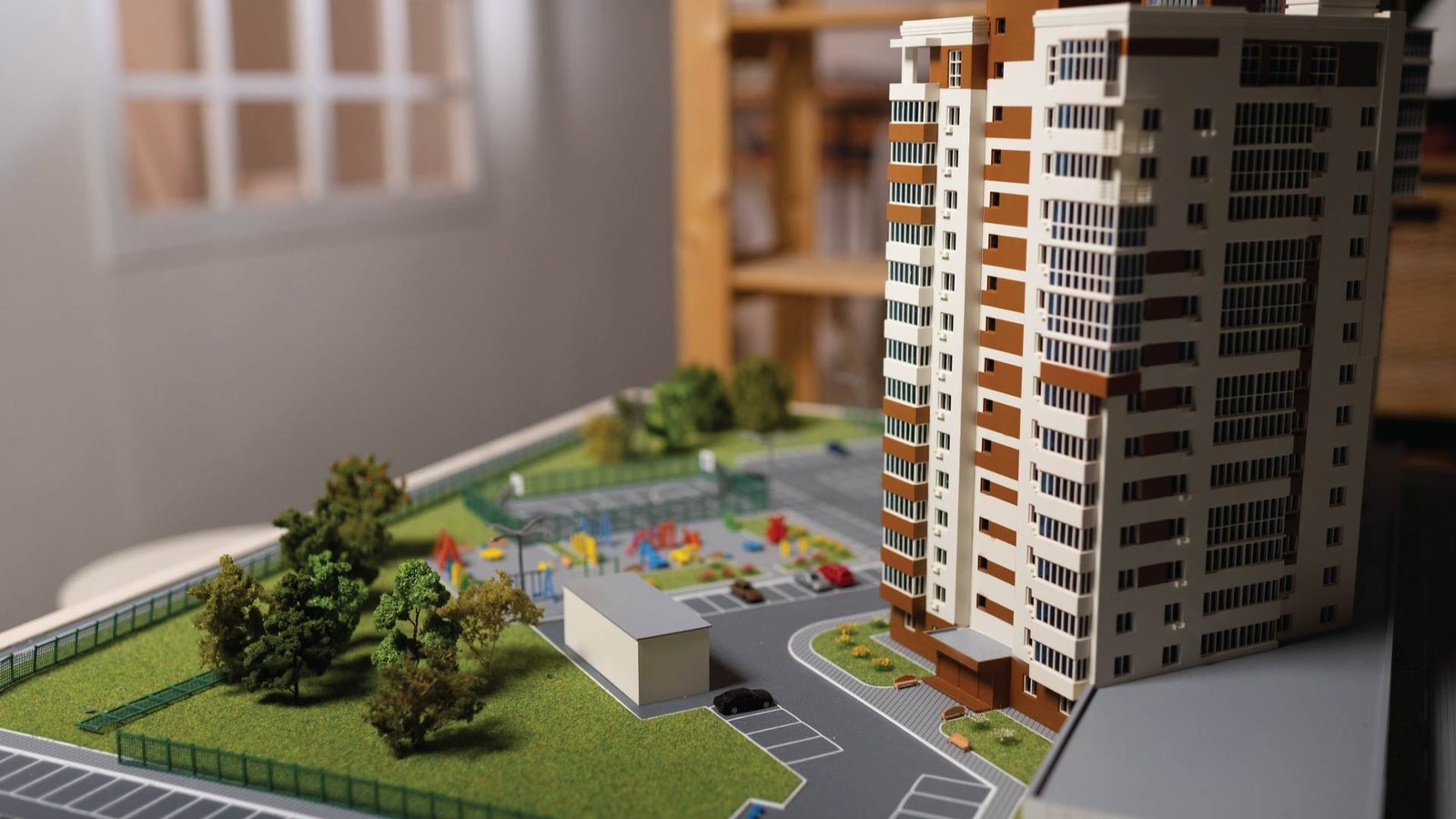 Model of an urban high-rise surrounded by amenities, symbolizing Cousins Properties’ vision for live-work spaces.