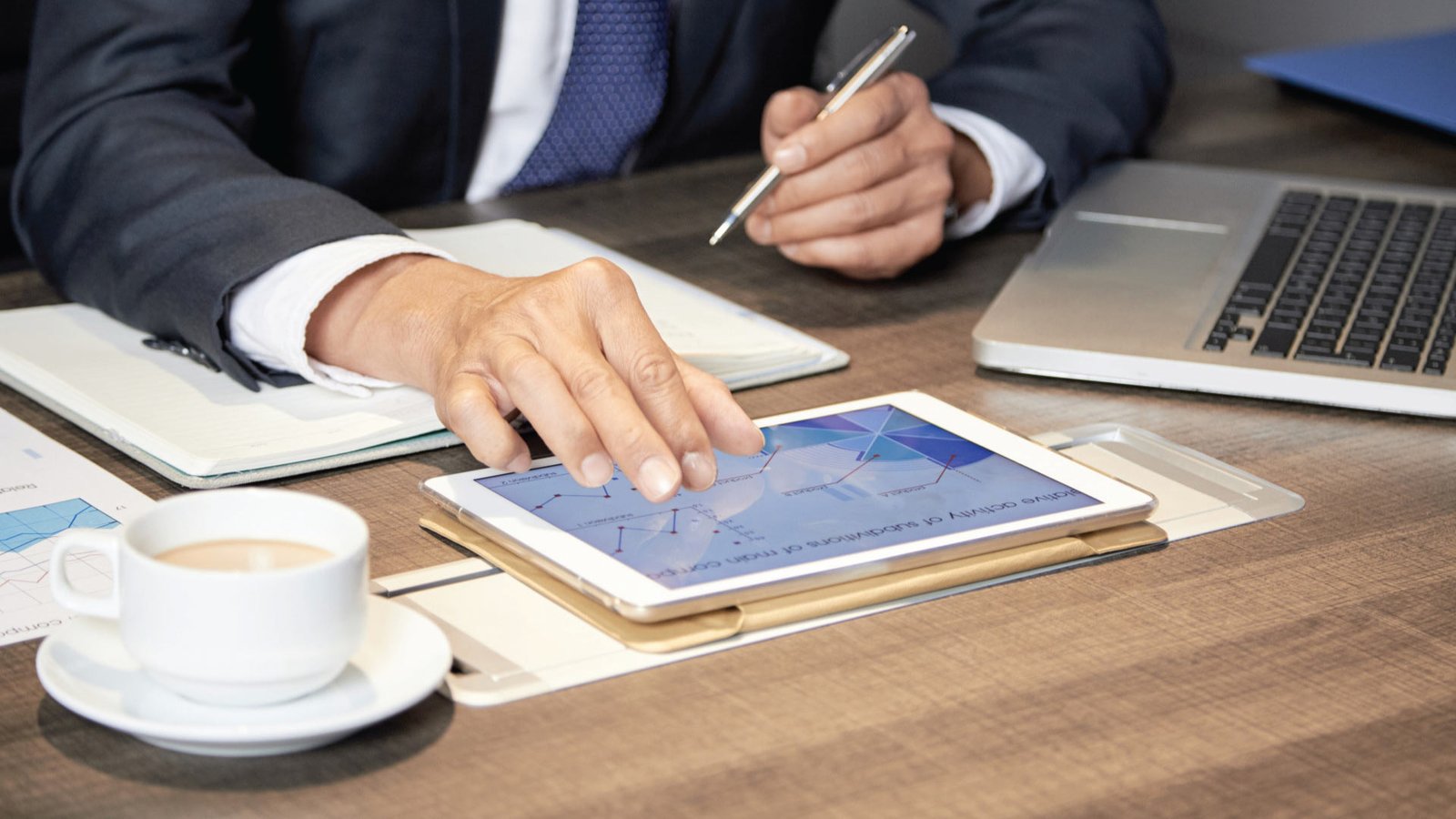 Knightvest team member evaluating property investment data on a touchscreen device to optimize portfolio performance.