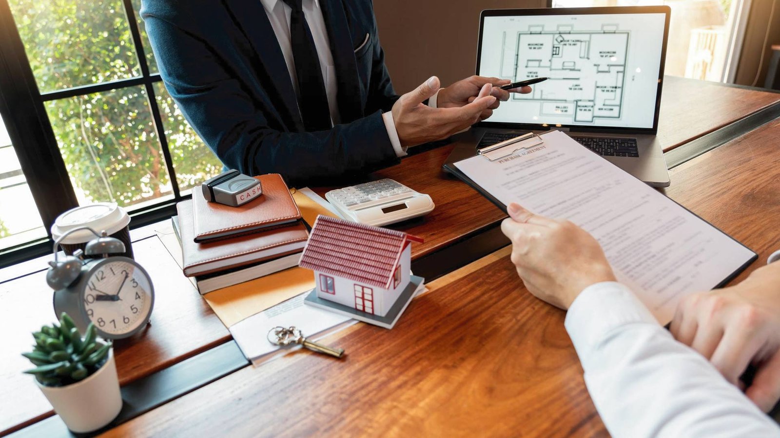 Lever property advisor reviewing floor plans and agreement paperwork with client.